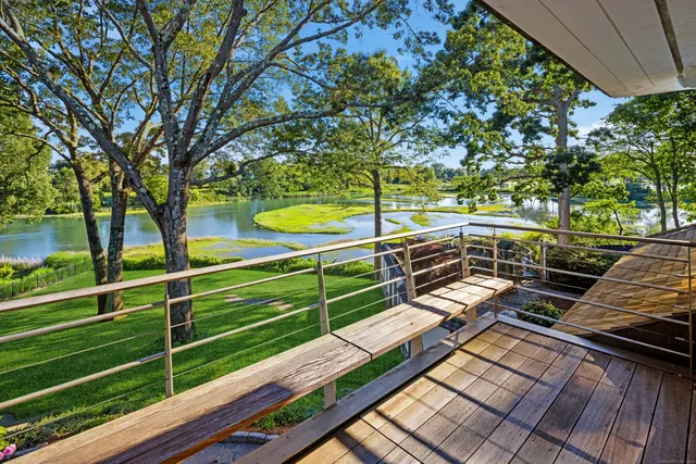 a view of a yard with wooden floor and fence