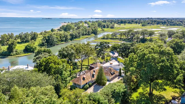 an aerial view of a houses with a yard and lake view