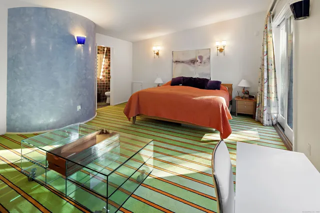 a bedroom with a bed and cabinets