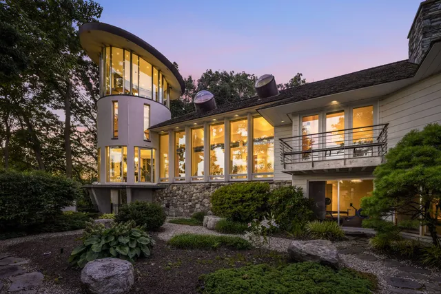 a front view of a house with a garden