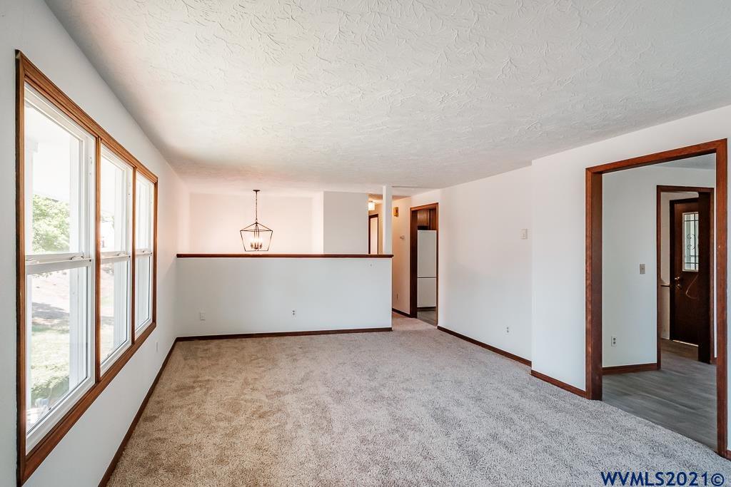 1278 Southwest Maple Street Dallas, OR 97338 - Photo 10 of 42 a view of a big room with windows and refrigerator