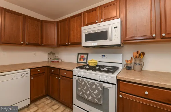 a kitchen with stainless steel appliances granite countertop a stove a microwave and cabinets
