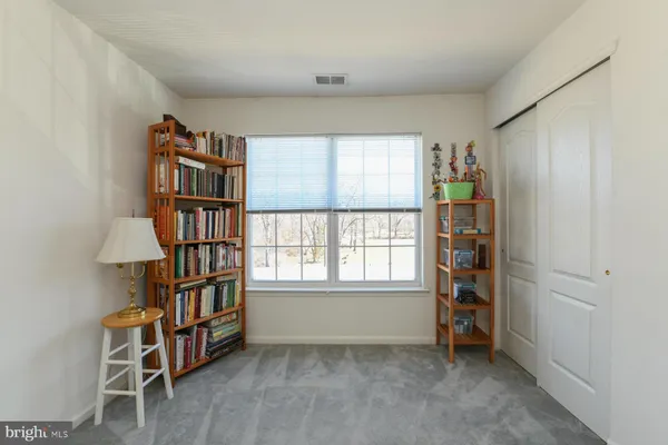 an empty room with windows and cabinet