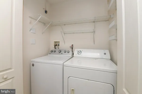a view of storage and utility room with washer and dryer