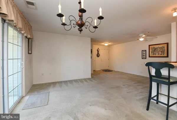 a view of a hallway with a chandelier