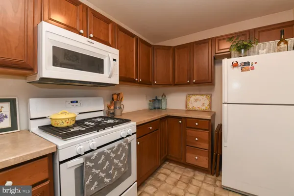 a kitchen with stainless steel appliances a stove a microwave and a refrigerator