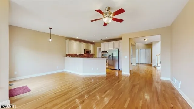 a view of a kitchen with a sink and a refrigerator