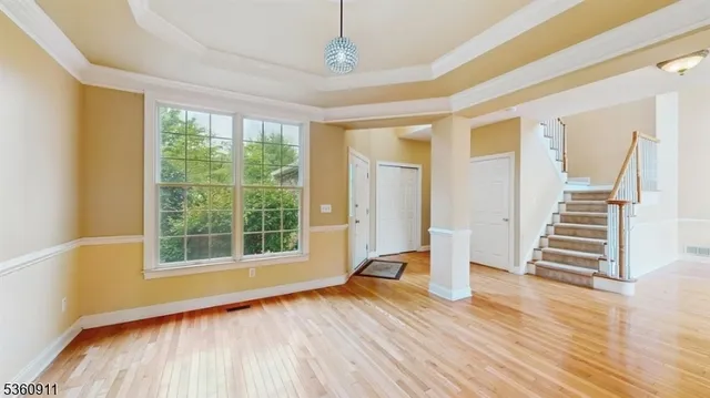 a view of wooden floor and windows in a room