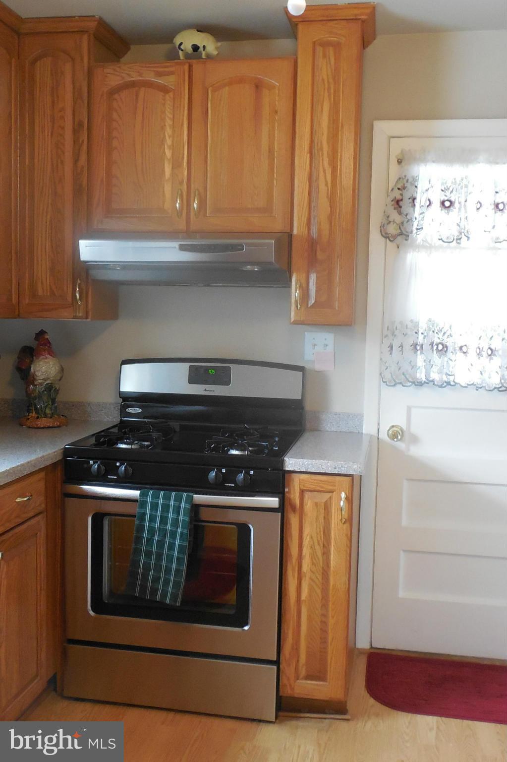 1322 Westburn Road Baltimore, MD 21228 - Photo 14 of 21 a stove top oven sitting inside of a kitchen