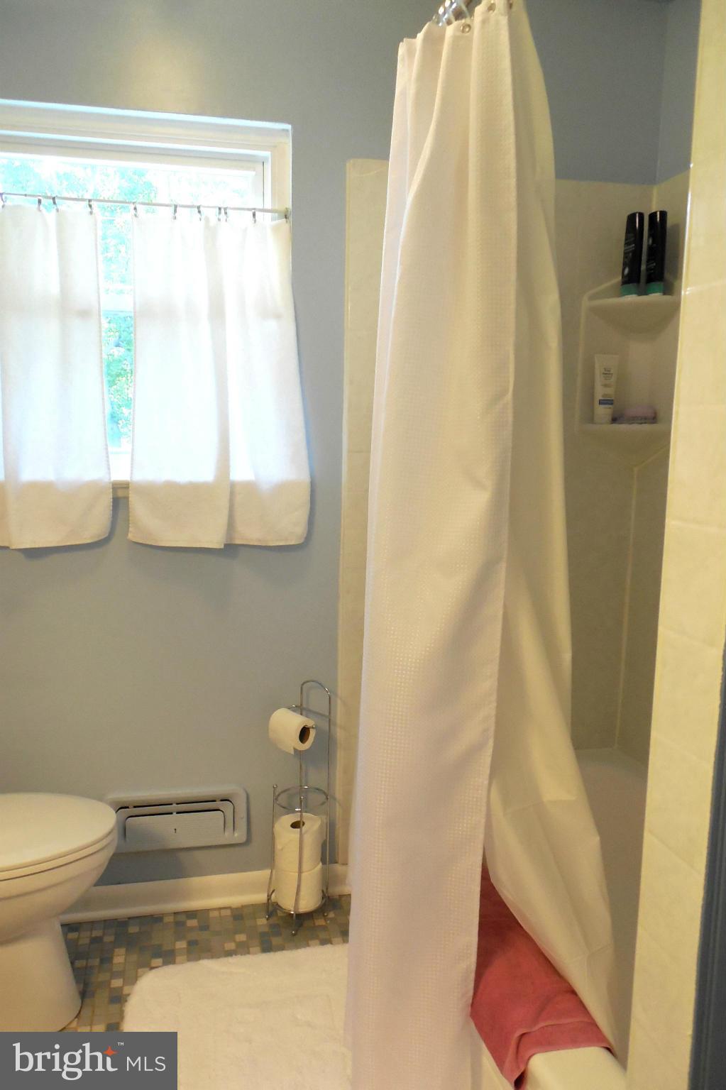 1322 Westburn Road Baltimore, MD 21228 - Photo 8 of 21 a bathroom with a toilet and a shower curtain