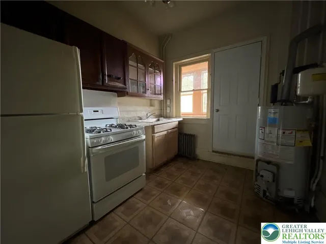 a kitchen with a sink stove and refrigerator