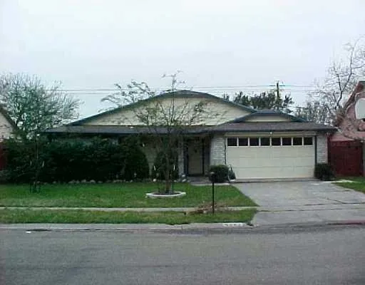 a view of a big house with a big yard and large trees