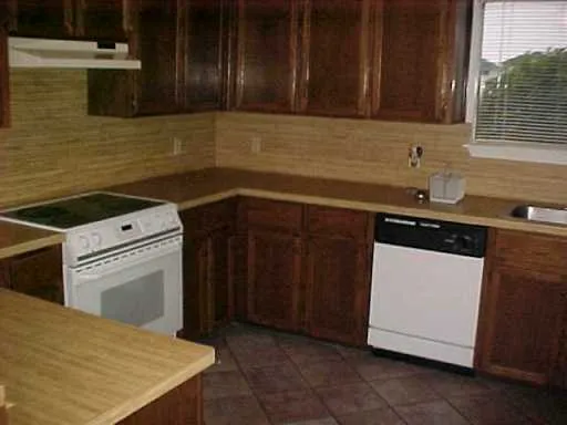a kitchen with a sink stove and cabinets