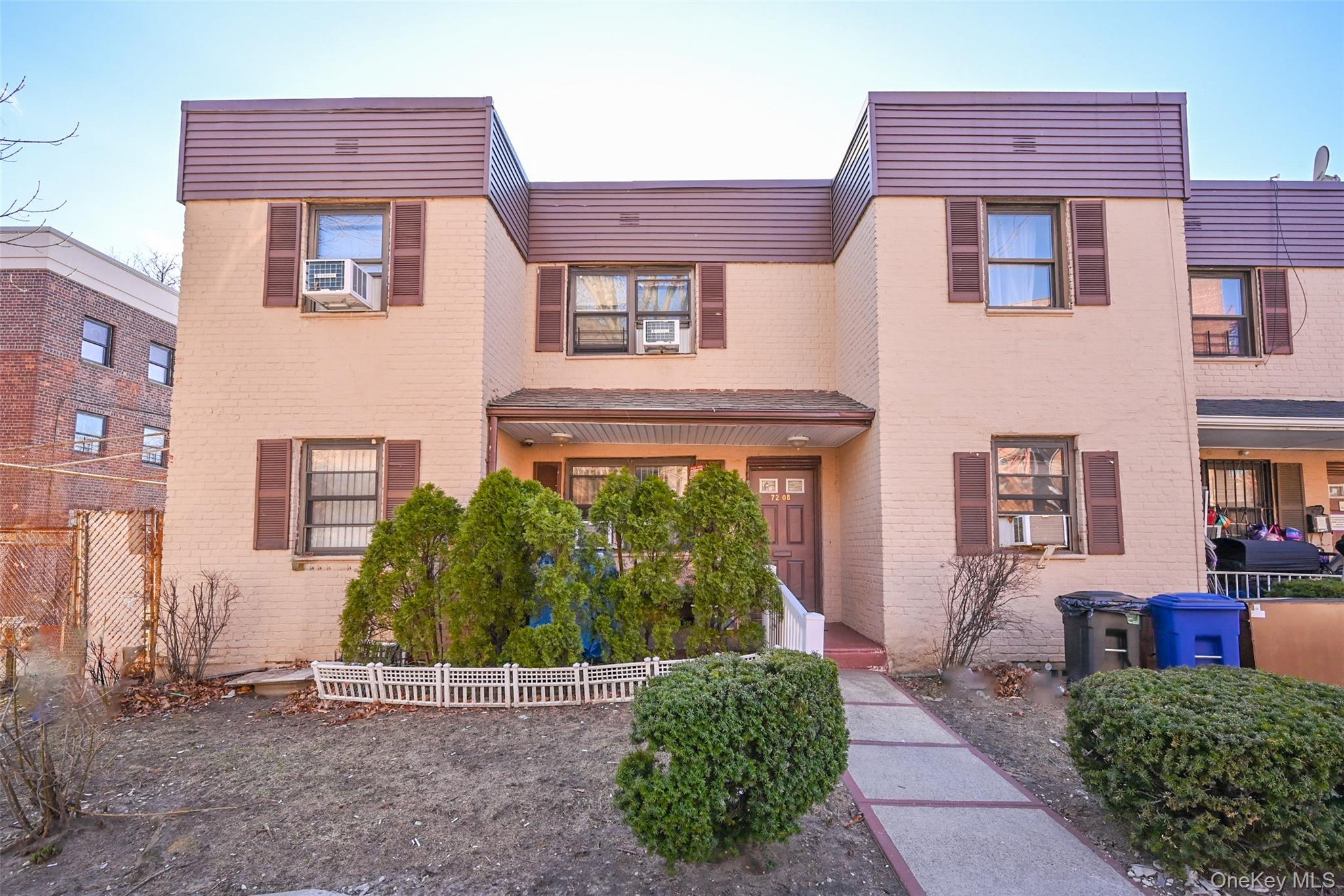 72-08 150th Street, Unit 199B Queens, NY 11367 - Photo 1 of 5 a front view of a house with a yard