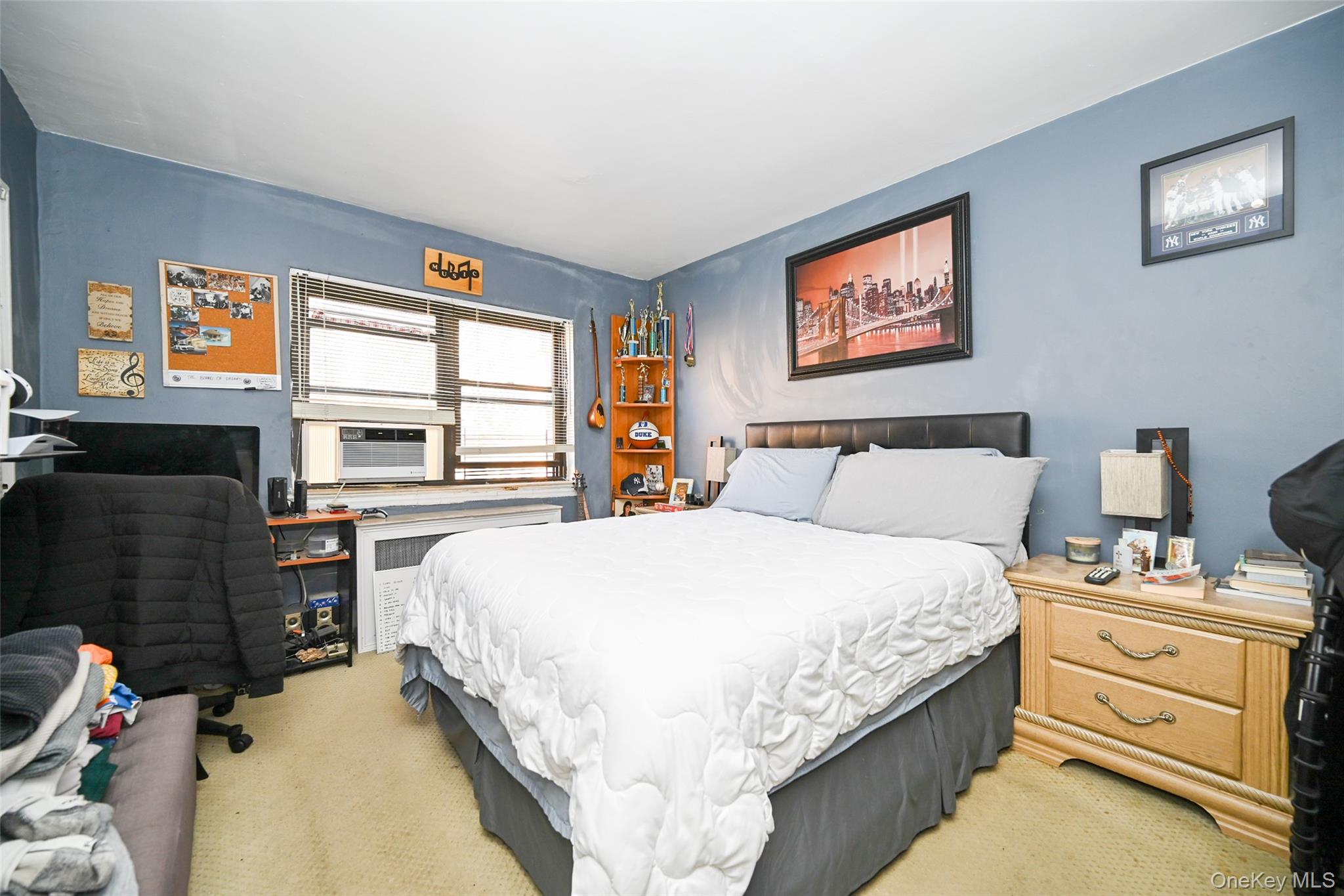 72-08 150th Street, Unit 199B Queens, NY 11367 - Photo 3 of 5 a bed room with a bed and a tv