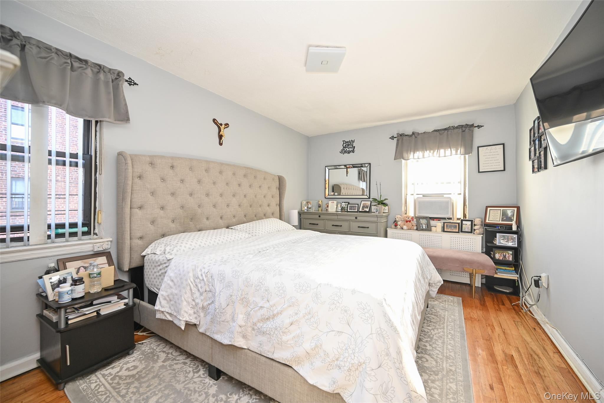 72-08 150th Street, Unit 199B Queens, NY 11367 - Photo 4 of 5 a bedroom with a bed and wooden floor