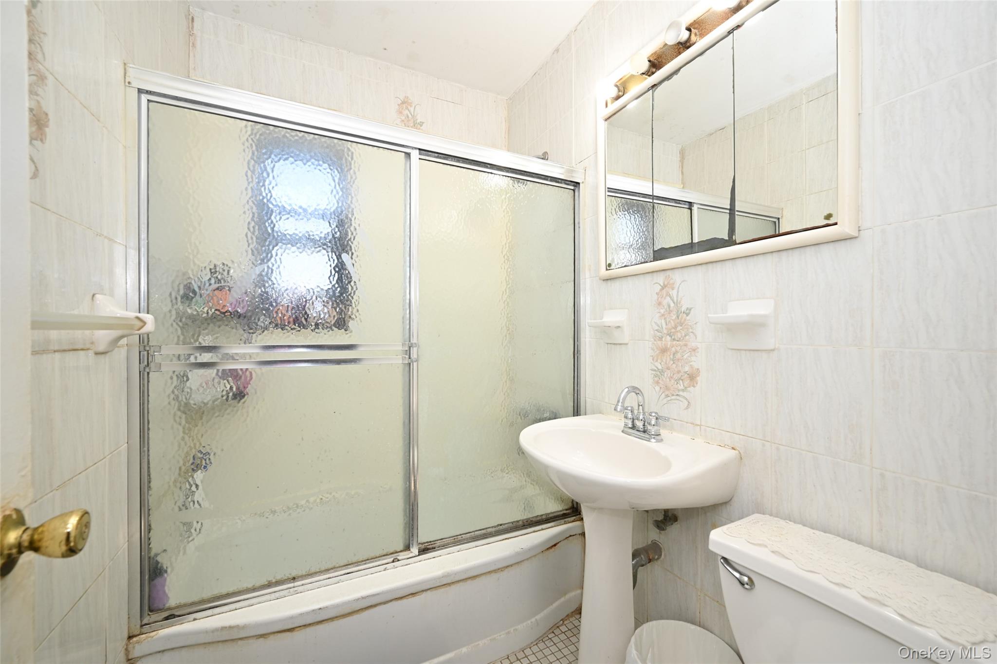 72-08 150th Street, Unit 199B Queens, NY 11367 - Photo 5 of 5 a bathroom with a sink toilet and shower