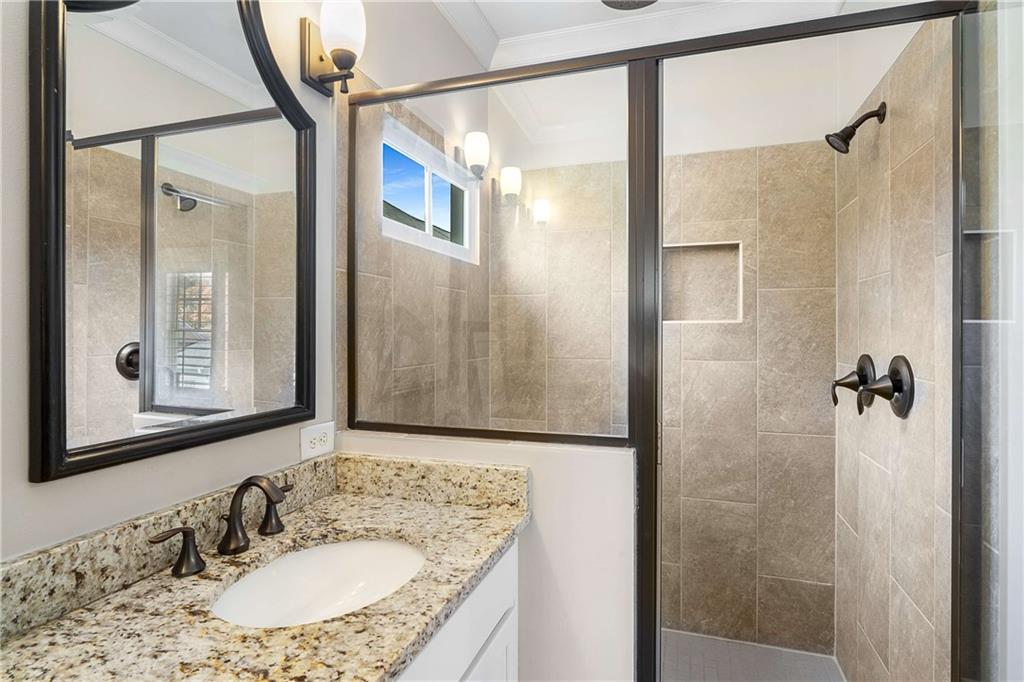 2003 Hibernia Bend Decatur, GA 30030 - Photo 29 of 52 a bathroom with a granite countertop shower sink and mirror