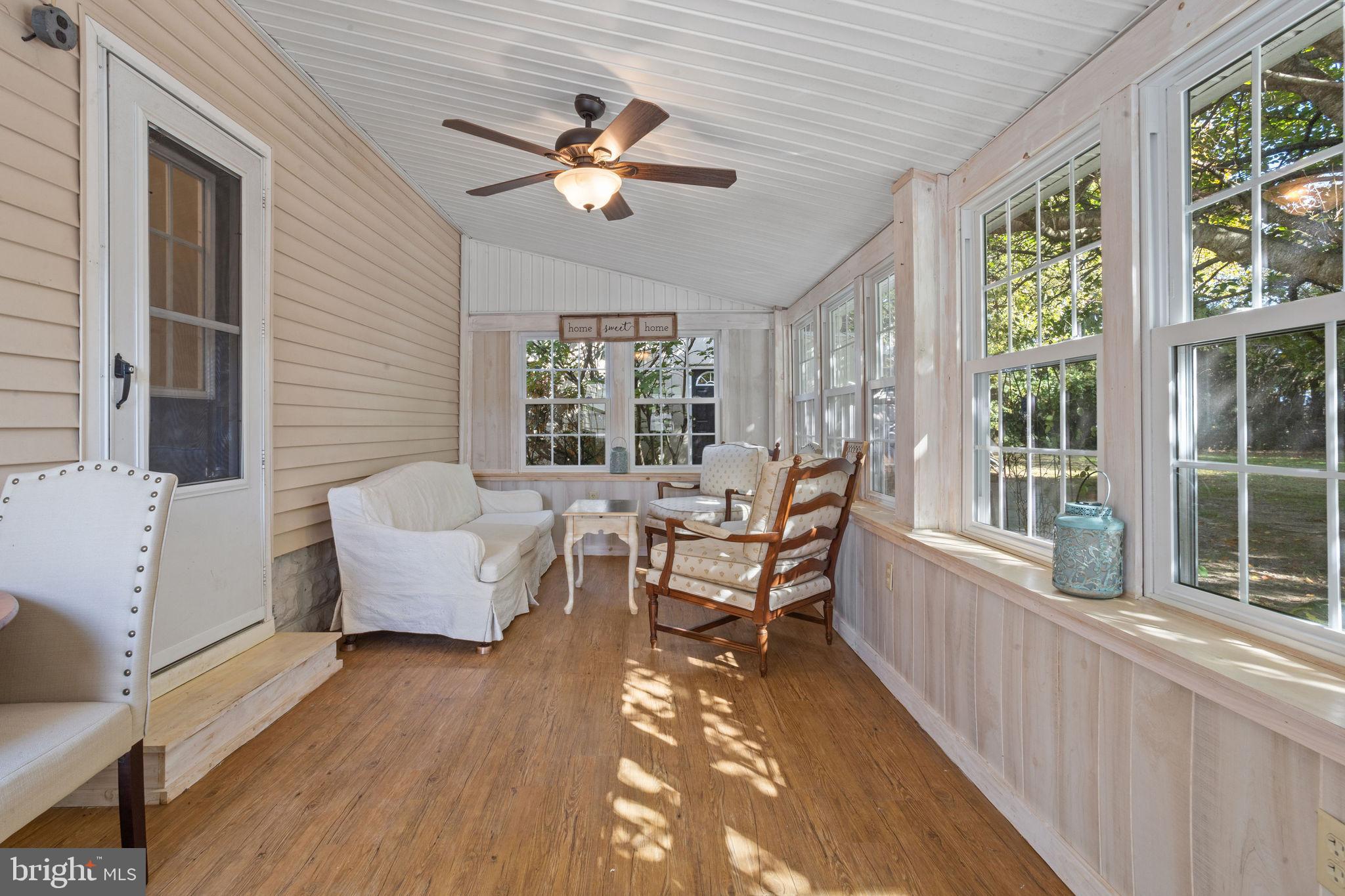 57 South Dupont Road Carneys Point, NJ 08069 - Photo 22 of 26 Talk, play, or share a meal on the enclosed porch.