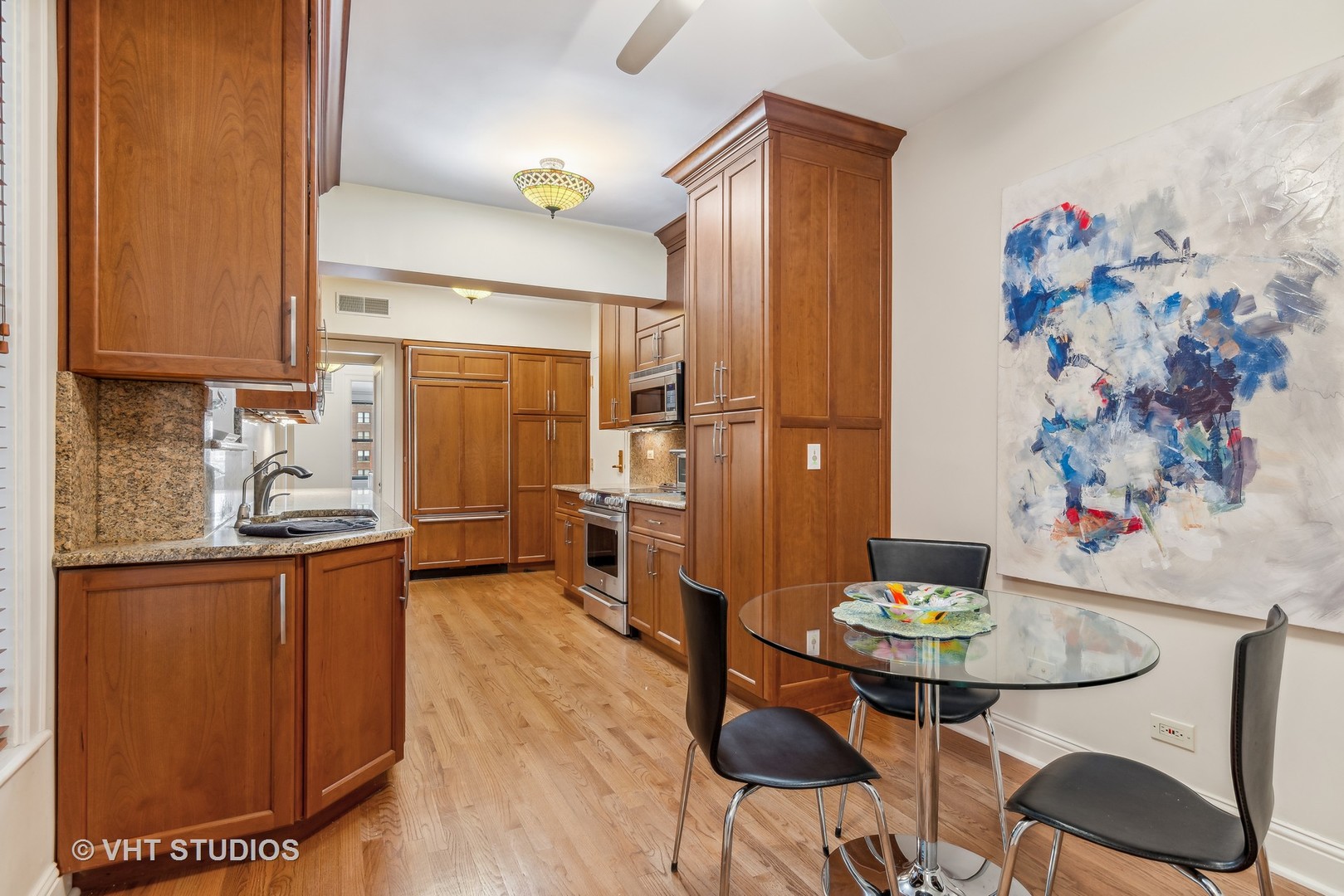3100 North Sheridan Road, Unit 8B Chicago, IL 60657 - Photo 11 of 28 a kitchen with granite countertop sink cabinets and stainless steel appliances