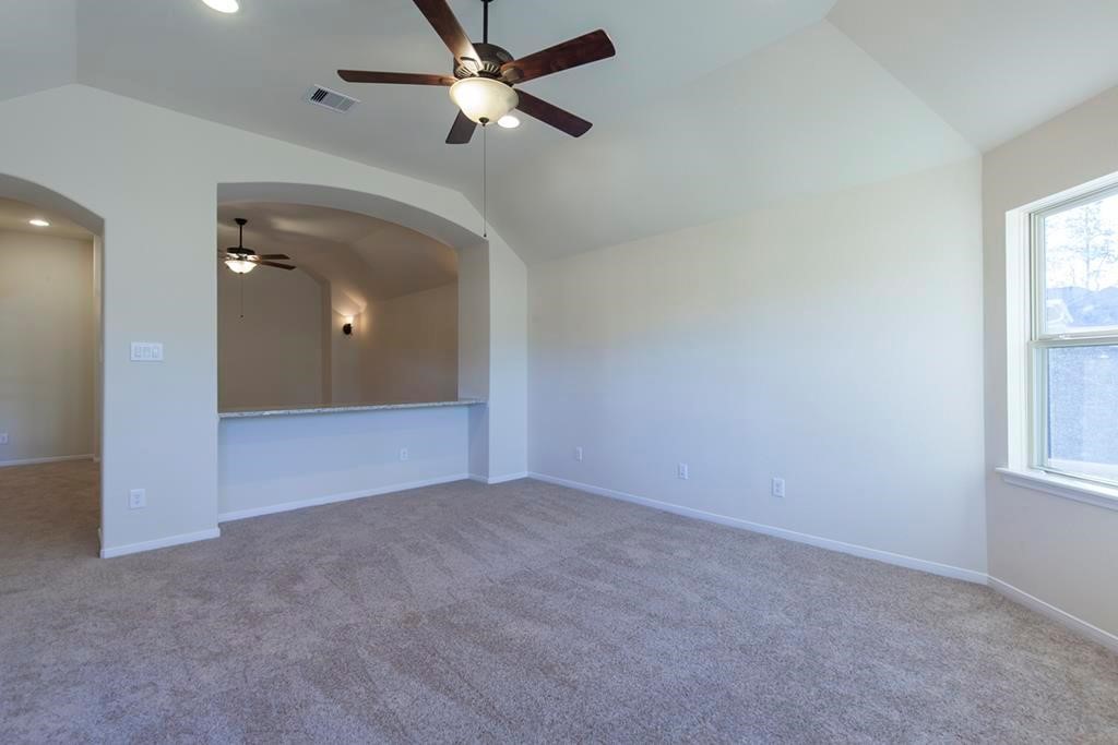 10402 Southern Hawker Conroe, TX 77385 - Photo 14 of 22 an empty room with windows and fan