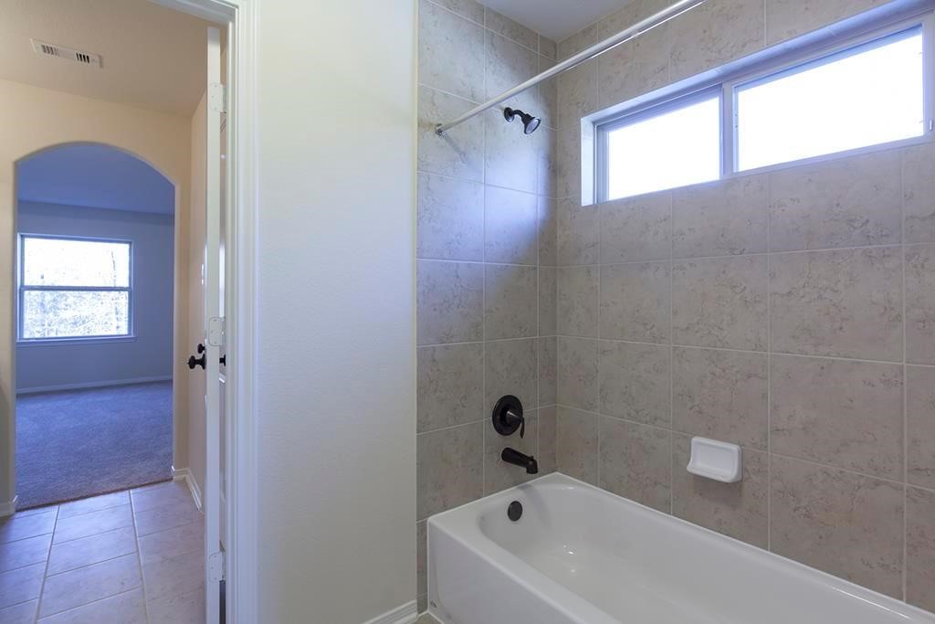10402 Southern Hawker Conroe, TX 77385 - Photo 18 of 22 a bathroom with a bathtub