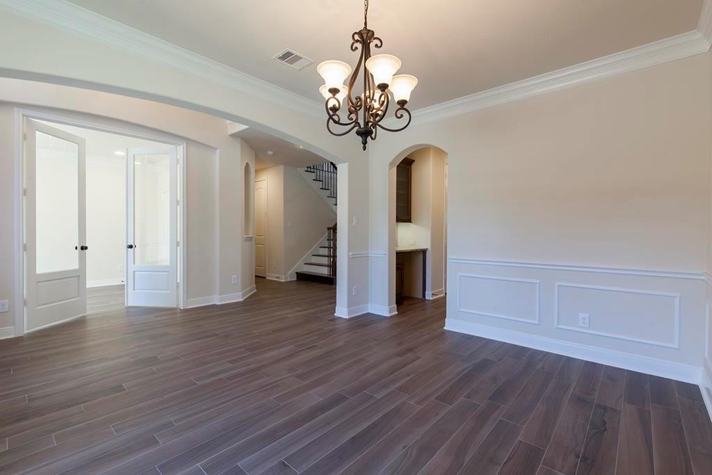 10402 Southern Hawker Conroe, TX 77385 - Photo 3 of 22 a view of an empty room with wooden floor