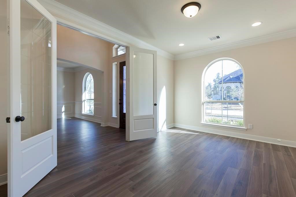 10402 Southern Hawker Conroe, TX 77385 - Photo 4 of 22 an empty room with wooden floor and windows