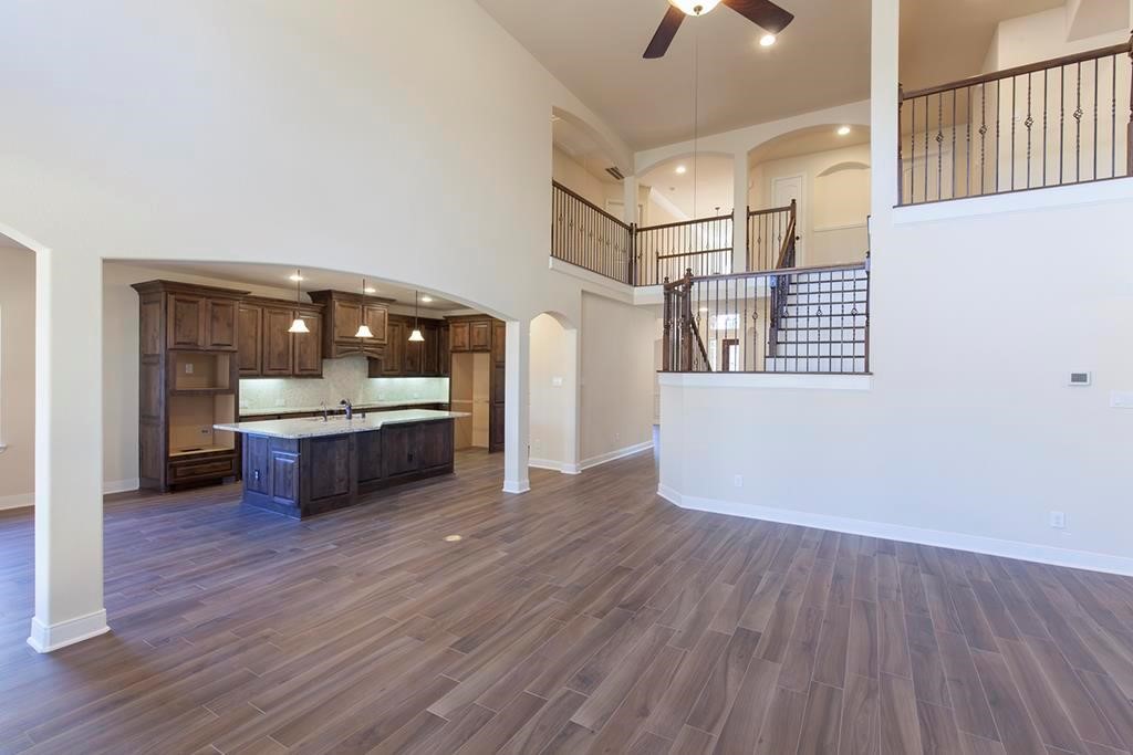 10402 Southern Hawker Conroe, TX 77385 - Photo 9 of 22 a view of a room with wooden floor and kitchen view