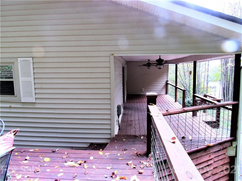 2506 Hemphill Road Waynesville, NC 28785 - Photo 23 of 37 a view of a balcony with chair and wooden floor