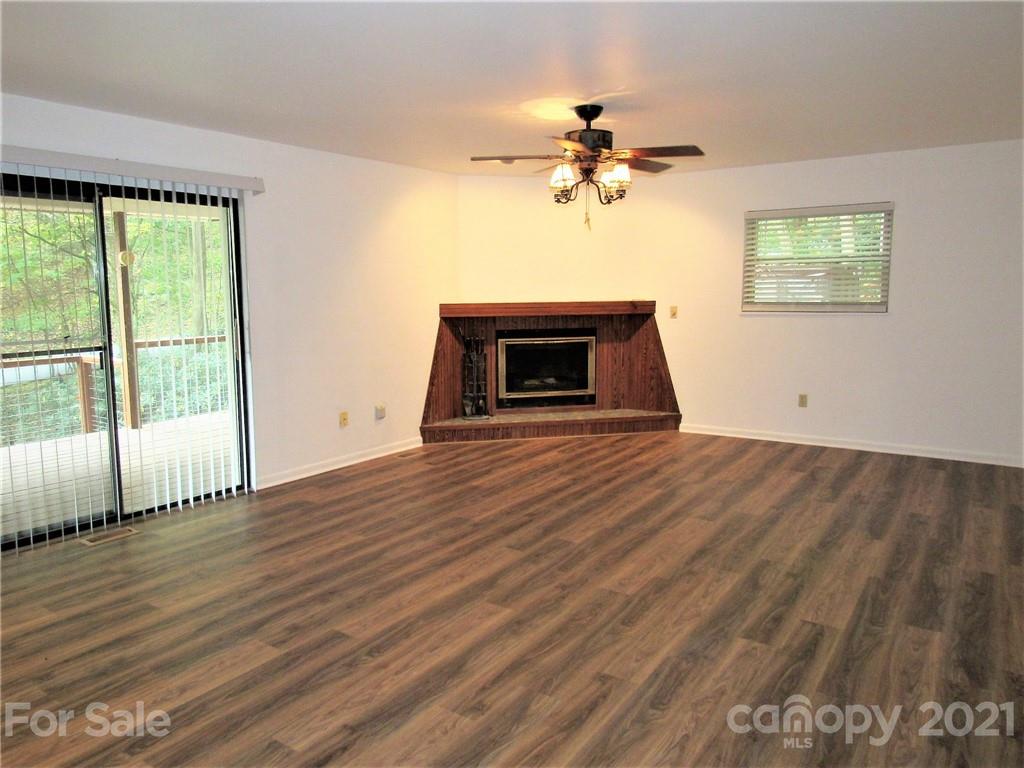 2506 Hemphill Road Waynesville, NC 28785 - Photo 5 of 37 a view of empty room with wooden floor and fan