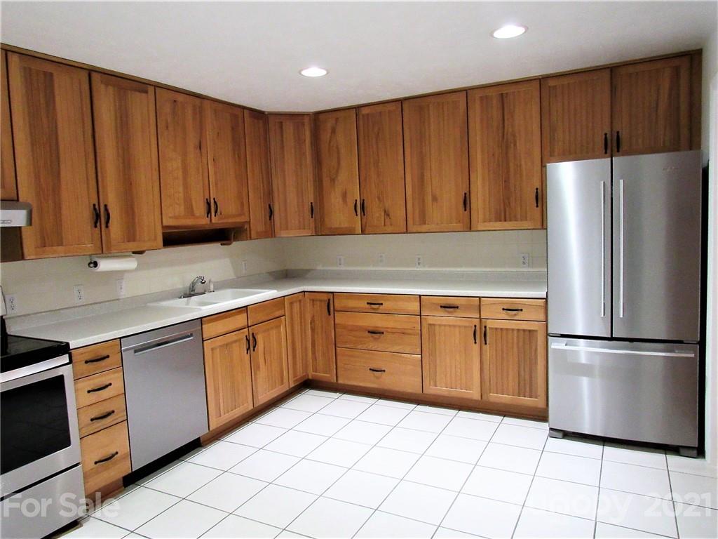 2506 Hemphill Road Waynesville, NC 28785 - Photo 7 of 37 a kitchen with stainless steel appliances granite countertop a refrigerator sink and cabinets