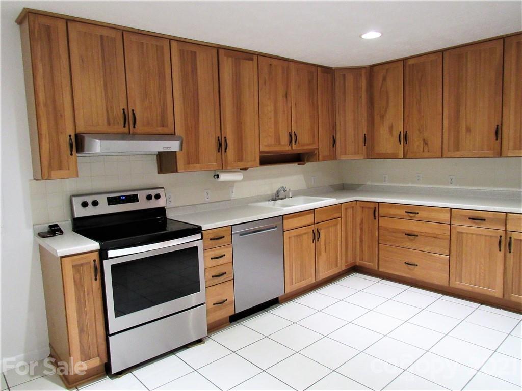 2506 Hemphill Road Waynesville, NC 28785 - Photo 8 of 37 a kitchen with a cabinets and white stove