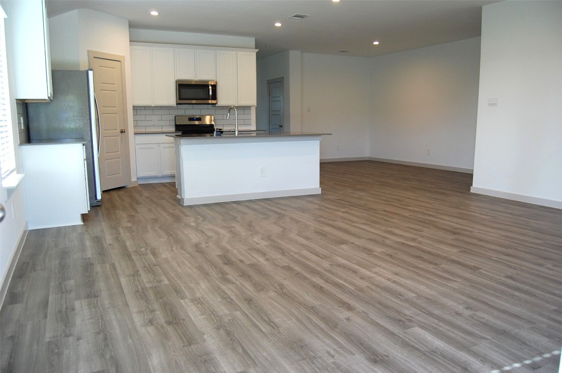 7702 Sleek Flock Lane Rosharon, TX 77583 - Photo 13 of 23 a view of a kitchen with a sink and a refrigerator