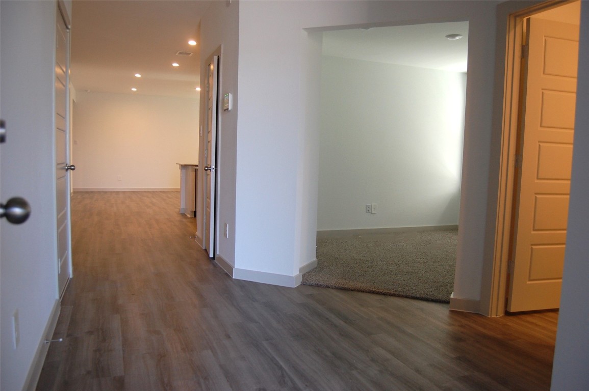 7702 Sleek Flock Lane Rosharon, TX 77583 - Photo 2 of 23 an empty room with wooden floor and windows