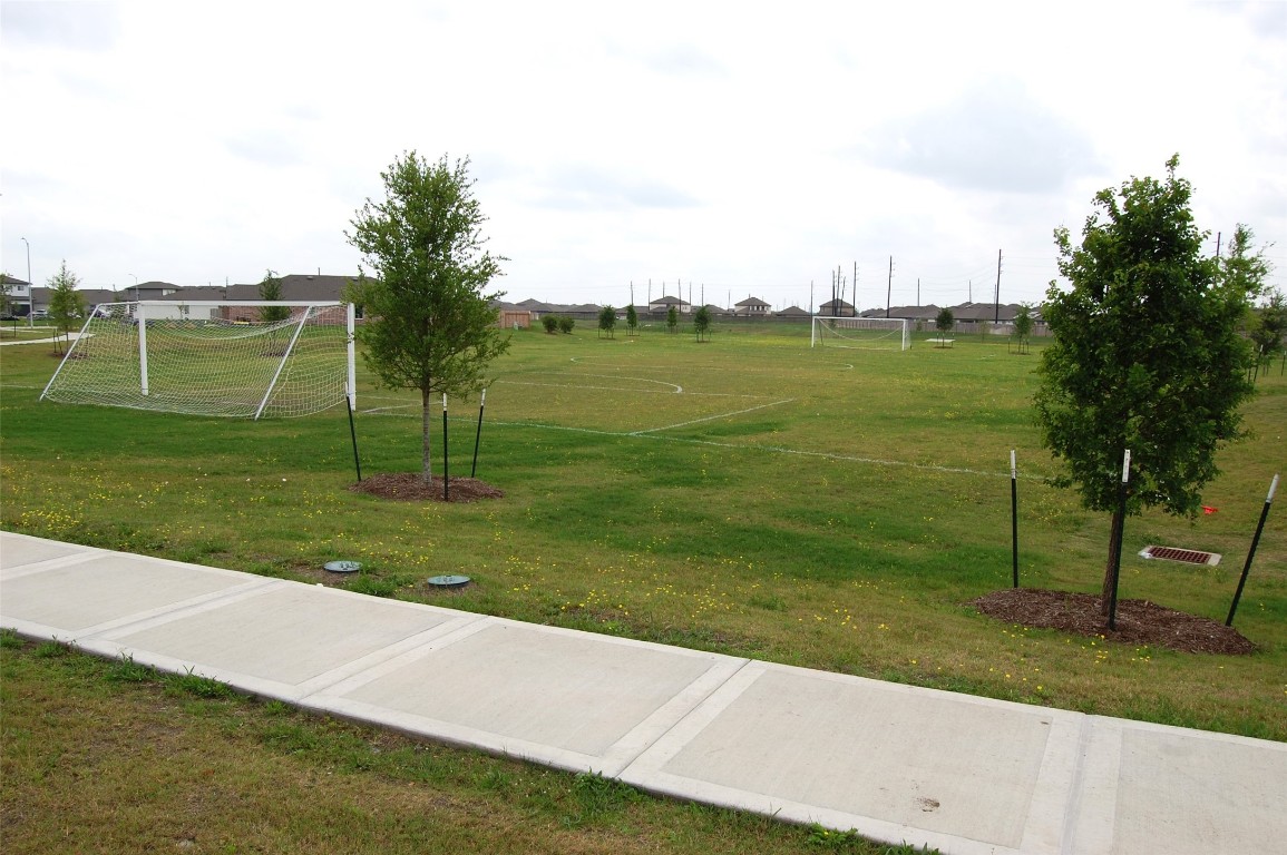 7702 Sleek Flock Lane Rosharon, TX 77583 - Photo 23 of 23 a view of a golf course with a lake