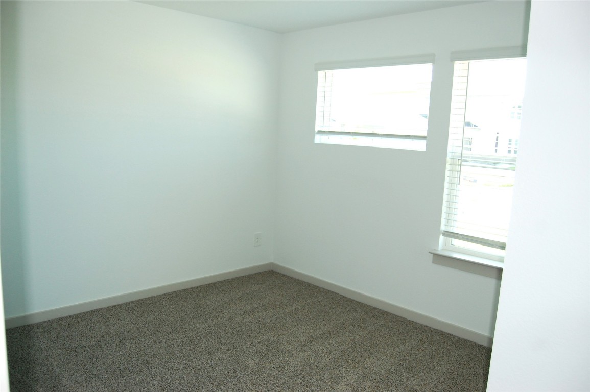 7702 Sleek Flock Lane Rosharon, TX 77583 - Photo 4 of 23 an empty room with a window