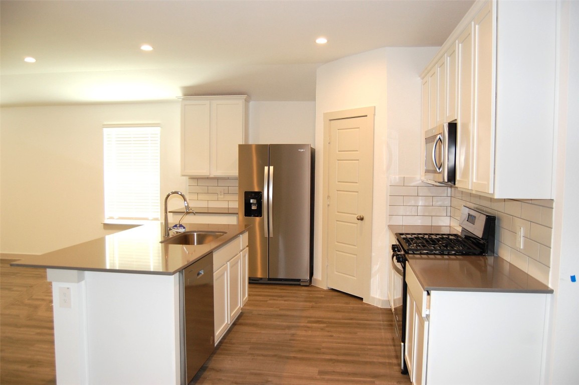 7702 Sleek Flock Lane Rosharon, TX 77583 - Photo 8 of 23 a kitchen with a refrigerator and a sink