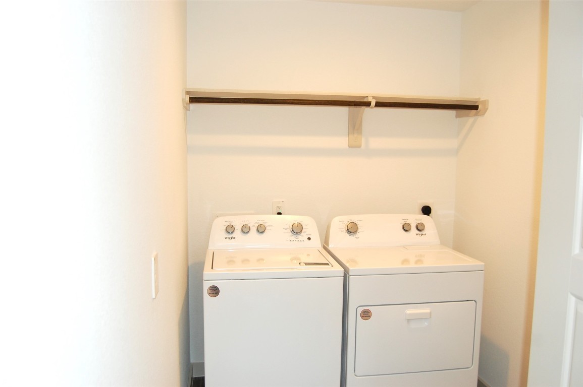 7702 Sleek Flock Lane Rosharon, TX 77583 - Photo 9 of 23 a utility room with dryer and washer
