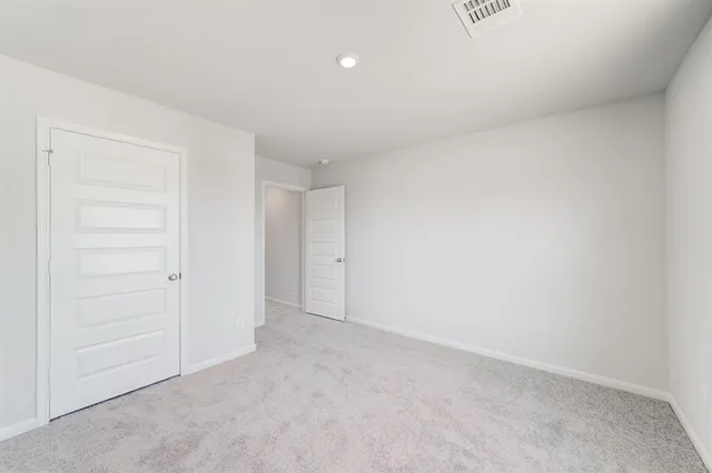 an empty room with closet area