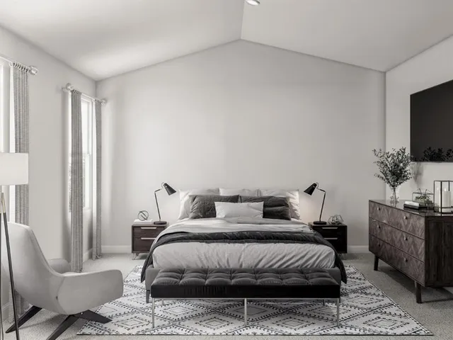 a bedroom with furniture and a flat screen tv