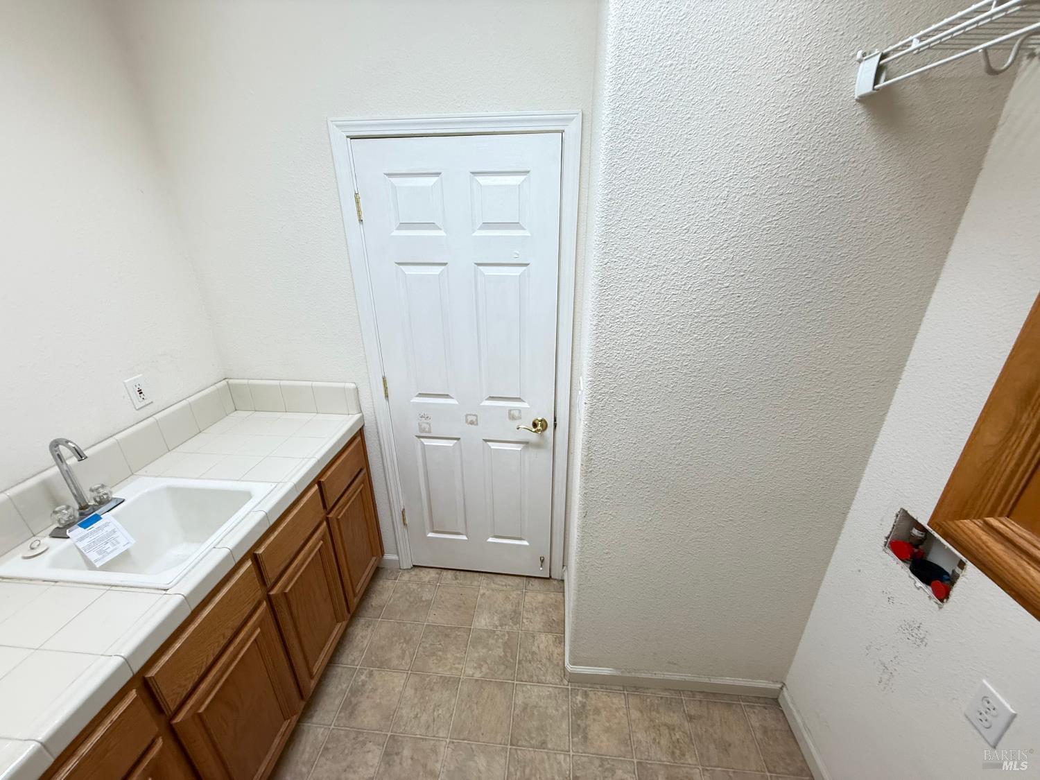 338 Gold Hills Drive Rio Vista, CA 94571 - Photo 22 of 27 a utility room with a sink a washer and dryer