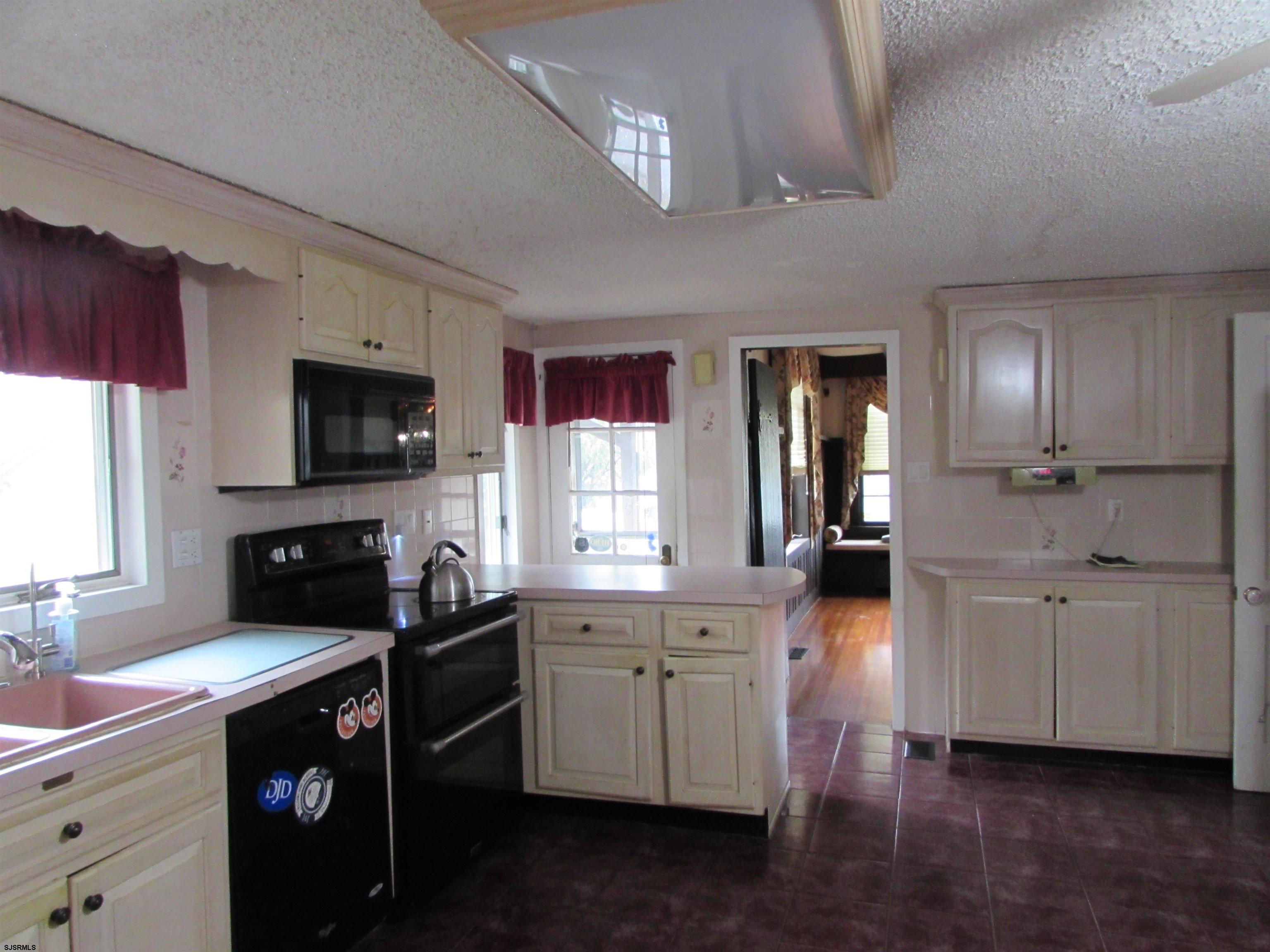 744 Shore Road Linwood, NJ 08221 - Photo 25 of 43 a kitchen with granite countertop a sink a stove and cabinets