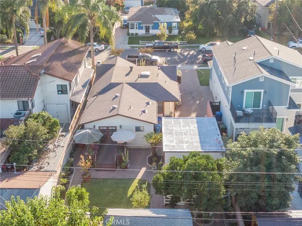 an aerial view of multiple houses with yard