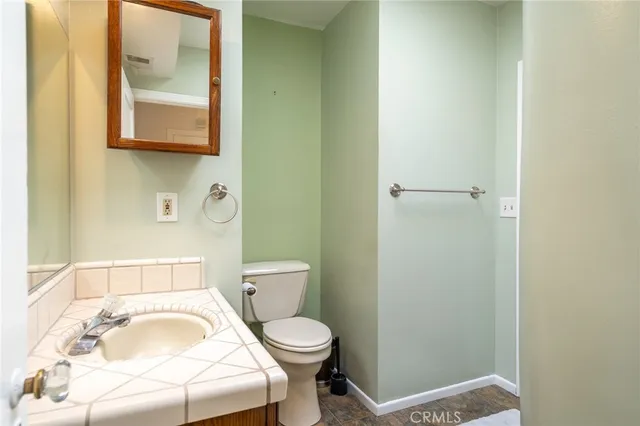 a white toilet sitting next to a bathroom sink