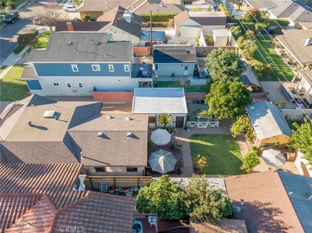 an aerial view of residential houses with outdoor space and parking