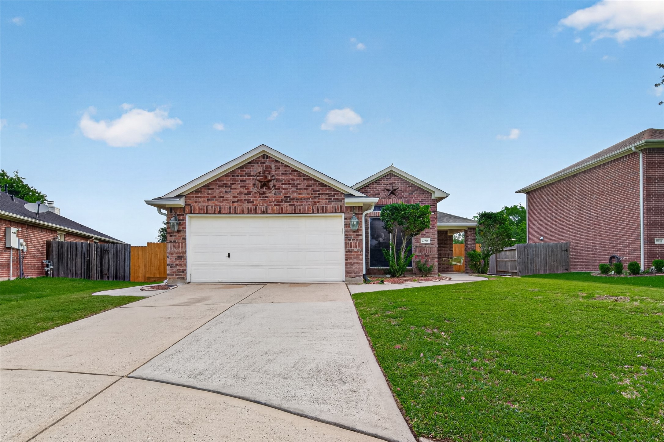 23914 Glengate Drive Spring, TX 77373 - Photo 2 of 49 a front view of a house with a yard and garage
