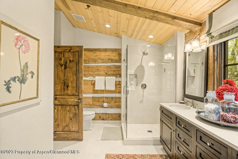 26 Altamira Ranch Road Basalt, CO 81621 - Photo 16 of 40 a bathroom with a granite countertop sink a mirror a shower and vanity