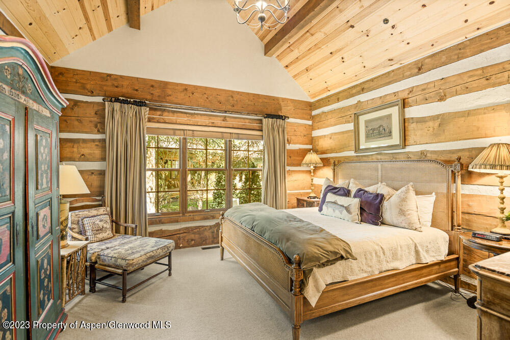 26 Altamira Ranch Road Basalt, CO 81621 - Photo 17 of 40 a bedroom with a bed and a dresser next to a window