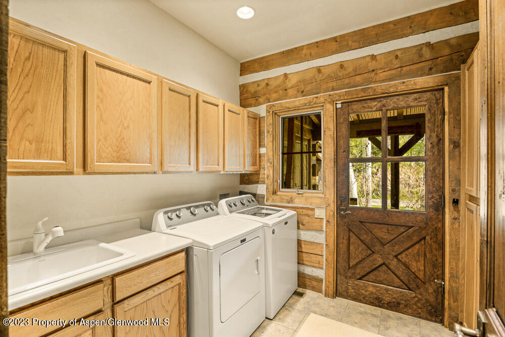 26 Altamira Ranch Road Basalt, CO 81621 - Photo 23 of 40 a utility room with a sink dryer and washer